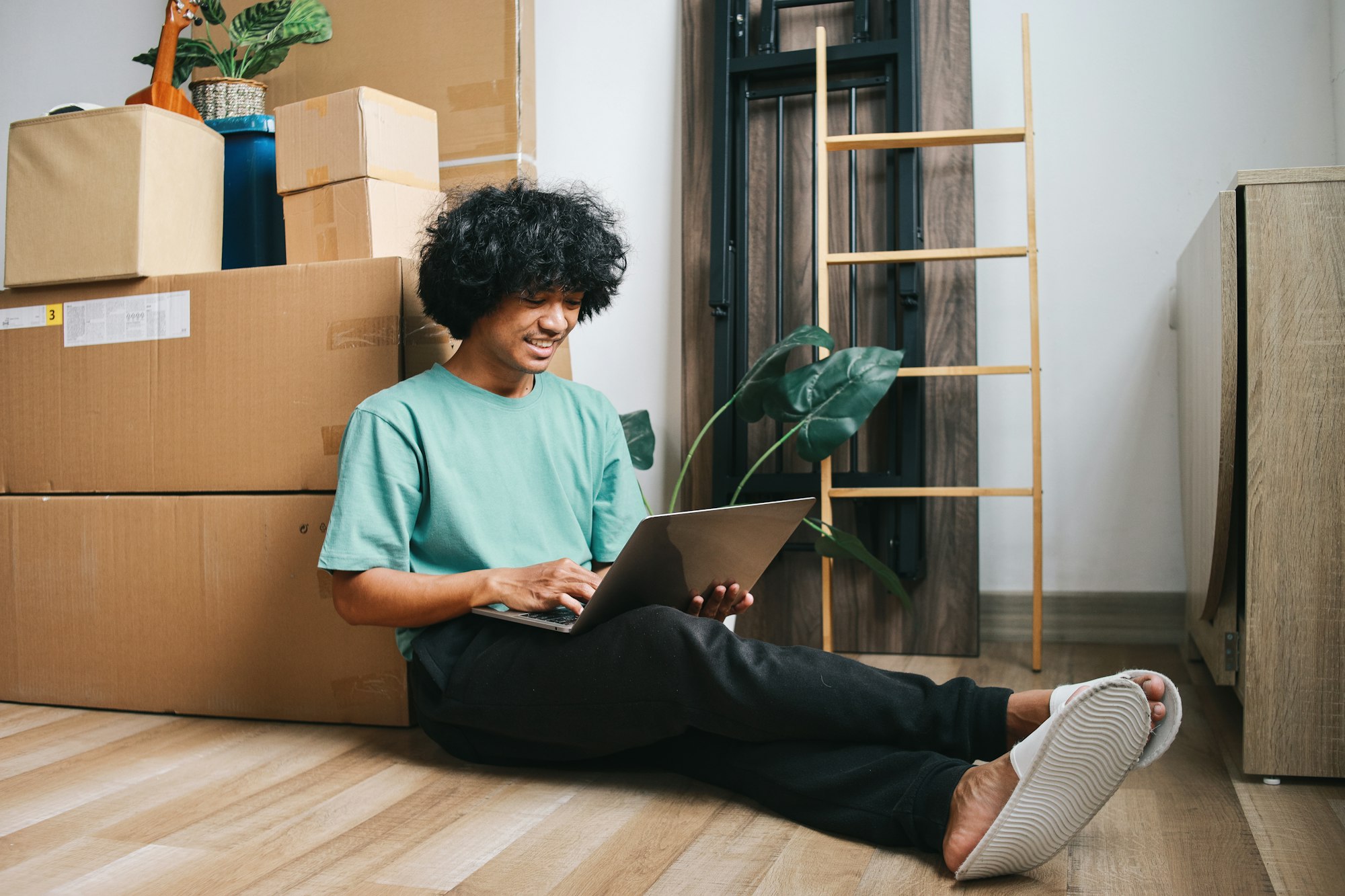 Young Man Checking List of Goods to Move to New House